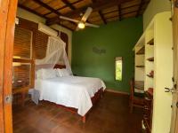 a bedroom with a white bed in a green room at Casa Riverstone in León