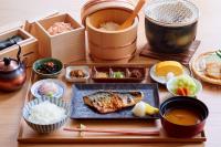 a table with a plate of food and bowls of food at remm Kagoshima in Kagoshima