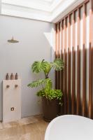 a plant in a pot sitting next to a wall at Rosewood Phuket in Patong Beach