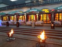 Un restaurante con mesas y sombrillas frente a un edificio. en Dolce by Wyndham Bad Nauheim, en Bad Nauheim