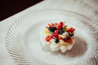a dessert on a white plate with fruit on it at Stella Due in Arabba