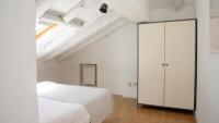 A bed or beds in a room at ÁTICO CENTRO HISTÓRICO MADRID