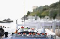 a table with two plates of food on top at Porto Plomari in Plomarion