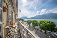 a balcony of a building with a view of the water at Romantic Laghée in Bellano