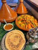 a table topped with plates of food and sauce at Riad Eucalyptus, hôtel de charme Essaouira in Essaouira
