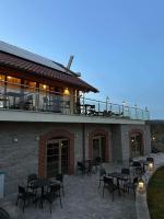 a patio with tables and chairs on top of a building at Dom na Wyłączność z Wanną z Hydromasażem, Sauną i Basenem in Mucharz