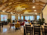 a restaurant with tables and chairs and a chandelier at Dom na Wyłączność z Wanną z Hydromasażem, Sauną i Basenem in Mucharz