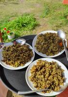 tres platos de comida en una mesa con cucharas en Mundum Farm Stay, en Dhulikhel