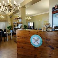 a restaurant with a counter with a teddy bear on it at Le Bay Lodge in Gordonʼs Bay
