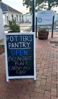 a sign for a potters pantry opengangan first run car parking at Le Bay Lodge in Gordonʼs Bay