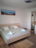Postel nebo postele na pokoji v ubytování APARTMAN IVANO