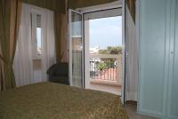 A bed or beds in a room at Hotel Residence Veliero