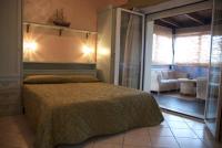 A bed or beds in a room at Hotel Residence Veliero