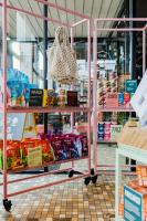 a store aisle with a rack of food in a store at The Social Hub Rotterdam Extended Stay in Rotterdam