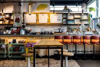 a bar with a wooden table and stools at The Social Hub Rotterdam Extended Stay in Rotterdam