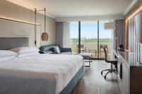 a hotel room with a large bed and a desk at Orlando World Center Marriott in Orlando