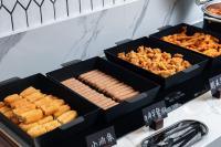 two black boxes filled with hot dogs and crackers at Atour Hotel Shanghai Pudong Chuansha Ancient Town in Shanghai