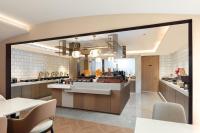 a kitchen with a counter and a dining room at Atour Hotel Shanghai Pudong Chuansha Ancient Town in Shanghai