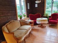 a living room with a couch and a table at Kvistrom Inn - Kviströms Gästgiveri in Munkedal