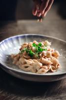 a plate of food with pasta on a table at Chogogo Dive & Beach Resort Curaçao in Jan Thiel