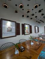 a dining room with tables and chairs and a projection screen at Baahu Villa in Siem Reap
