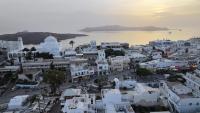 an aerial view of a white city with a body of water at Hotel Santorini in Fira
