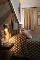 Łóżko lub łóżka w pokoju w obiekcie Hotel Chaberton