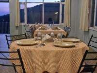 a set of tables with plates and napkins on them at Hotel City Gold - Hotel in Dharamshala in Dharmsala
