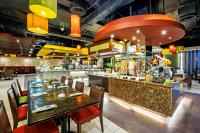 a restaurant with a bar with wooden tables and chairs at Waterfront Cebu City Hotel & Casino in Cebu City
