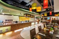 a restaurant with a counter and tables and chairs at Waterfront Cebu City Hotel & Casino in Cebu City