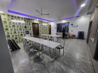 a meeting room with tables and chairs in a room at Raj Residency Gurgaon in Gurgaon