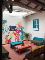 a room with a table and a wall with a mural at The Best Adventure Hostel in San Gil