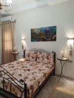 Postel nebo postele na pokoji v ubytování Evening Rose Villa