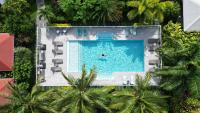 an overhead view of a pool with a person in the water at Hôtel &amp; Villa Le Cocotel in Saint-François
