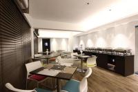 a restaurant with tables and chairs and a counter at Spring Hill Hotel and Service Apartments in Dhaka