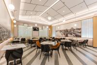 a restaurant with tables and chairs in a room at Atour Hotel Suzhou Wangting in Suzhou