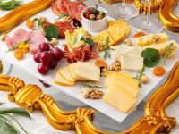 a plate of cheese and other foods on a table at Hotel de l'Opera Hanoi - MGallery in Hanoi