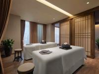a hotel room with two beds with white tables at Hotel de l'Opera Hanoi - MGallery in Hanoi