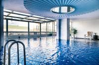 a pool in a building with a blue ceiling at Hotel de l'Opera Hanoi - MGallery in Hanoi
