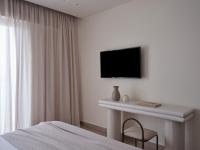 A television and/or entertainment centre at Atlantica Thalassa Hotel