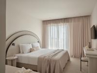 A bed or beds in a room at Atlantica Thalassa Hotel