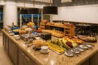 a buffet of fruits and vegetables on a counter at BOOK A FLAT Jardim Paulista em Hotel in Sao Paulo