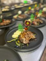 een tafel vol borden eten op een tafel bij Hill Garden Resort Hotel in San Ignacio