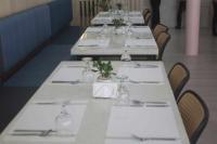 una fila de mesas en un restaurante con manteles blancos en Albergo Hotel, en Baguio