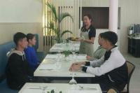 un grupo de personas sentadas en una mesa en un restaurante en Albergo Hotel, en Baguio