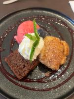a plate of food with dessert on a table at Familiehotel La Randulina in Ramosch