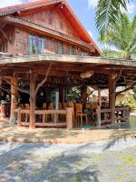 a log cabin with a table and chairs in front of it at Sun-San Thalane Resort in Ban Laem
