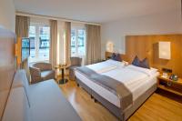 Łóżko lub łóżka w pokoju w obiekcie Hotel Maximilian - Stadthaus Penz