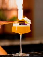 a drink in a glass on a table at L'Horloge - Appart'Hotel proche de Disneyland in Montévrain