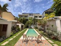 a swimming pool in the backyard of a house at La Ramona Charming Hotel in Tamarindo